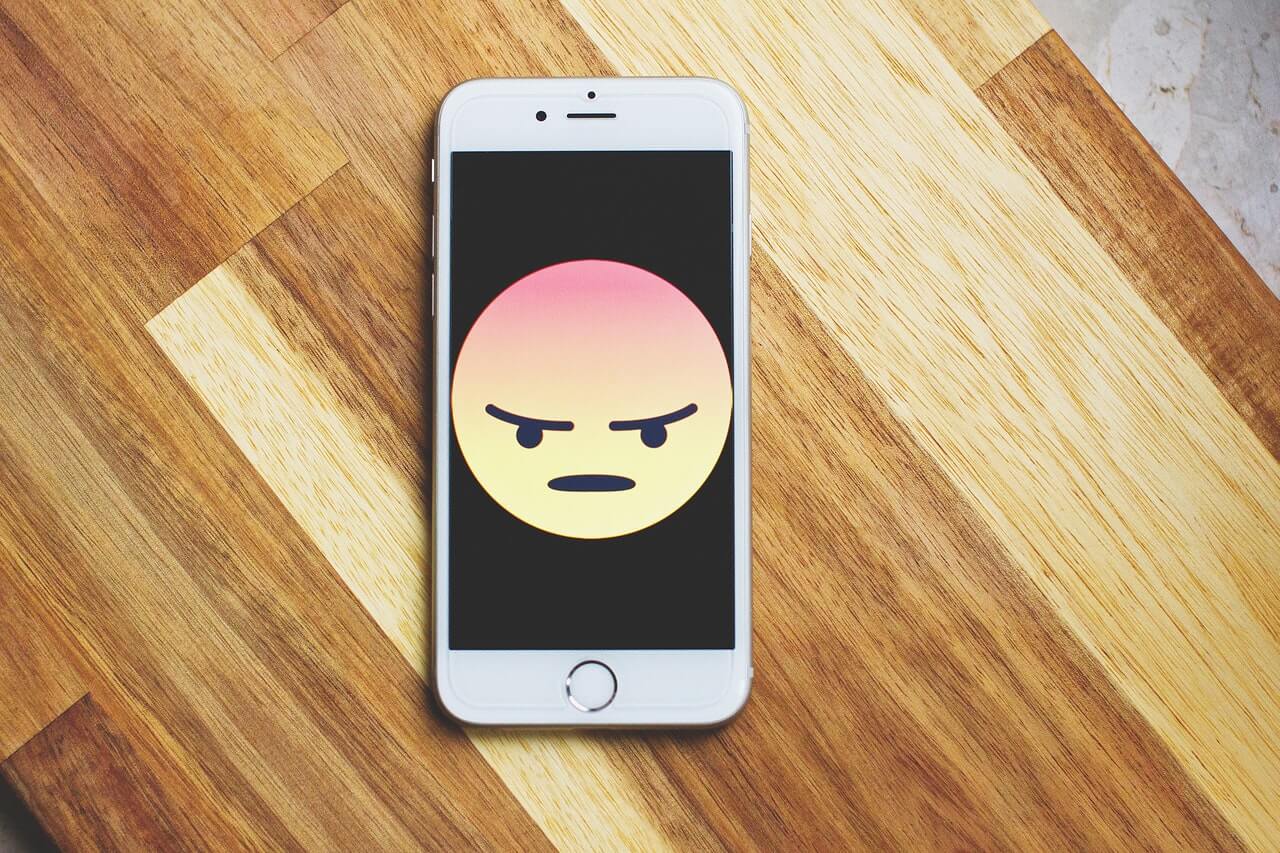 Angry emoticon on phone.