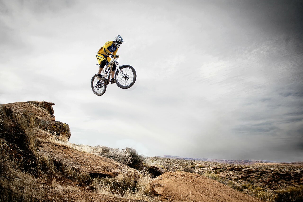 A mountain biker in mid-jump