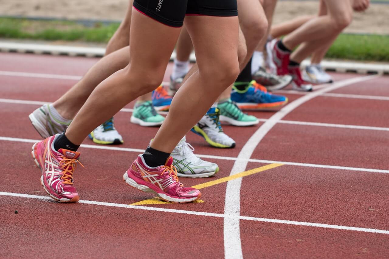 Colourful shoes at starting line of race track