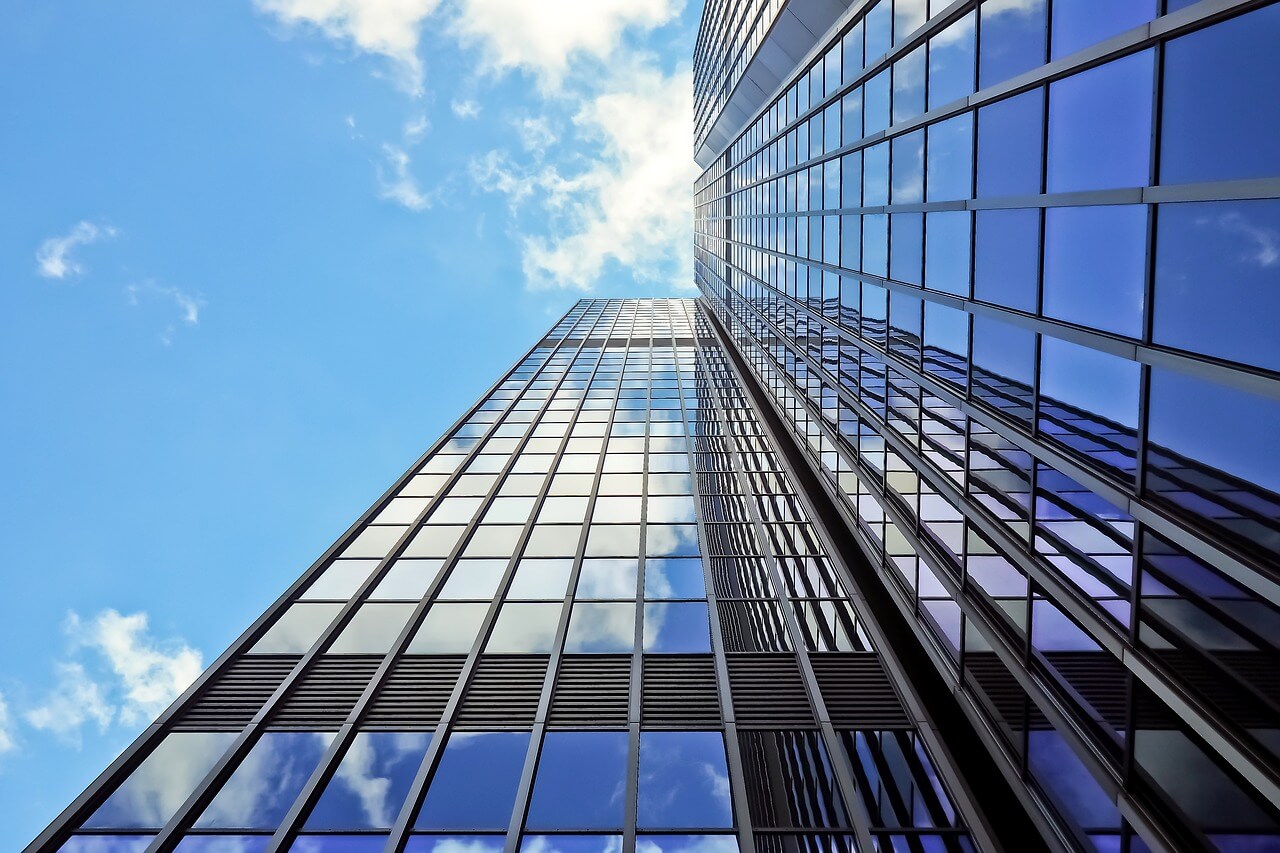 Looking up at a mirrored skyscraper.