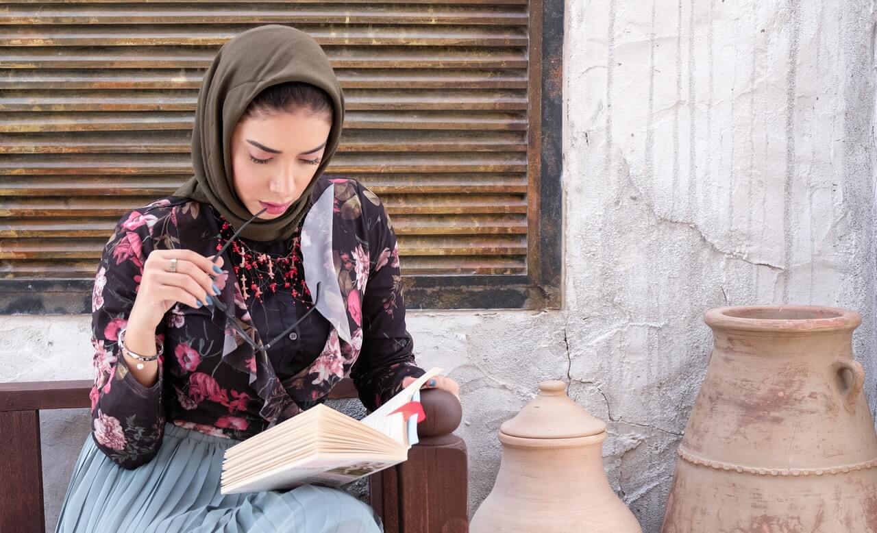 Woman sitting and reading a book thoughtfully